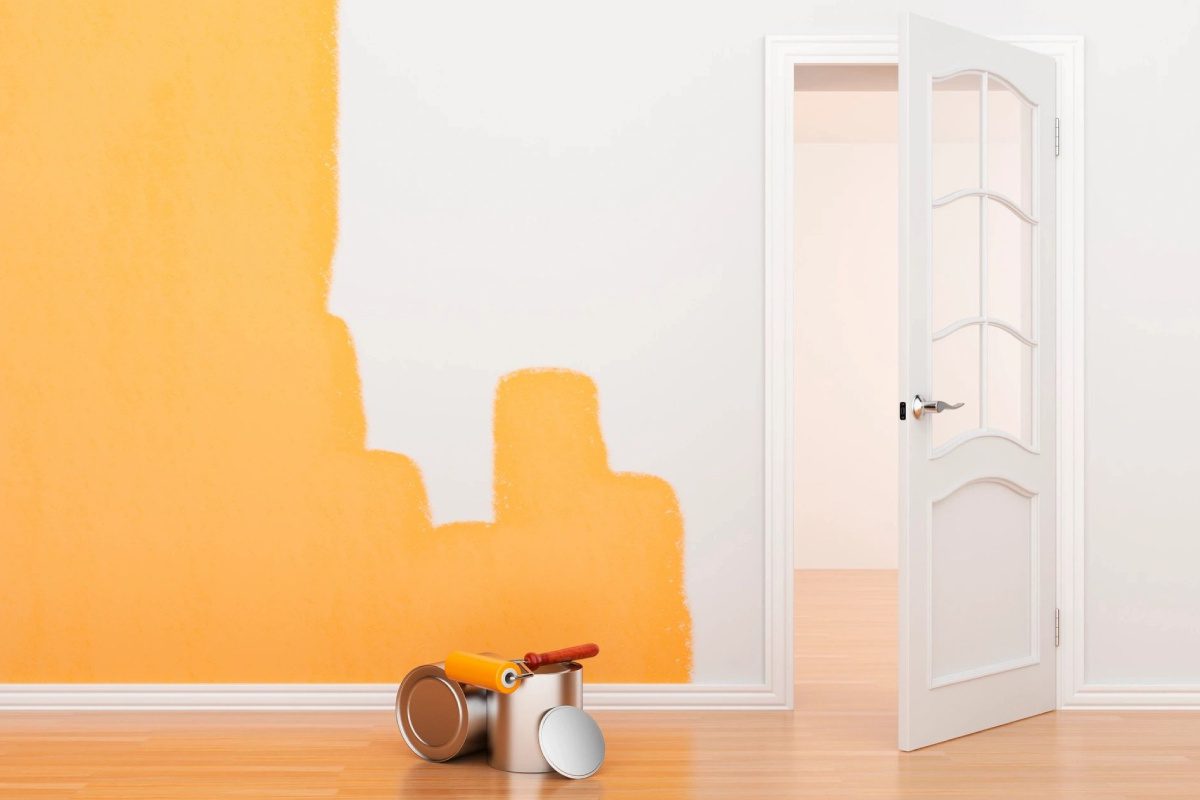 A room with orange walls and white doors.