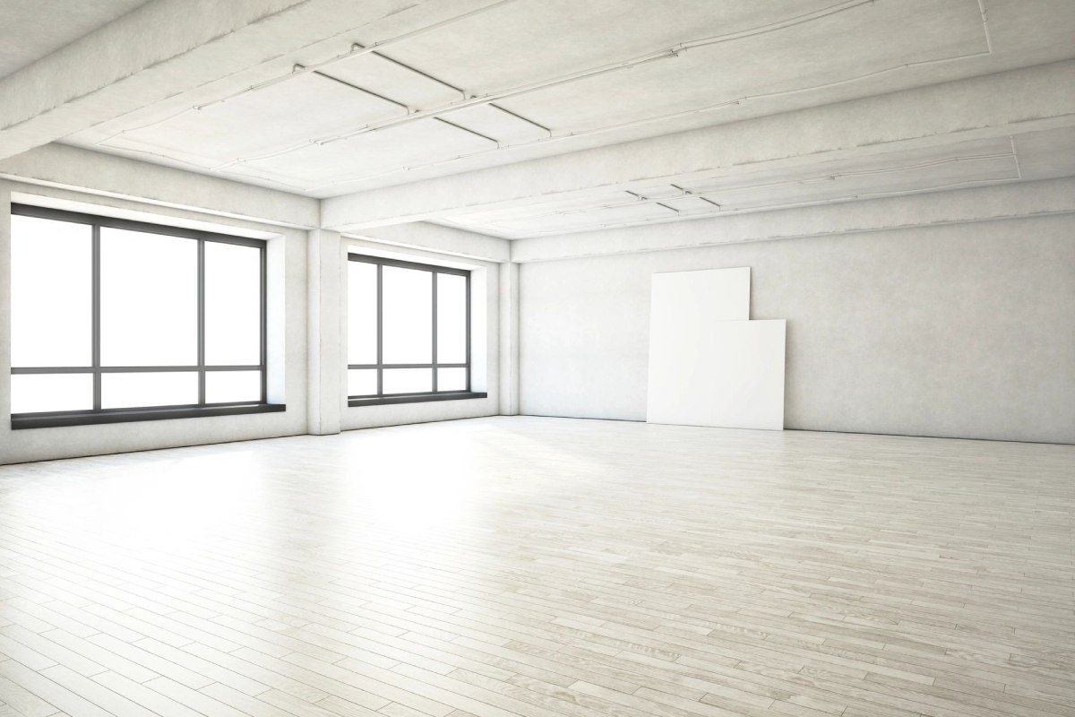 A large empty room with white walls and floors.