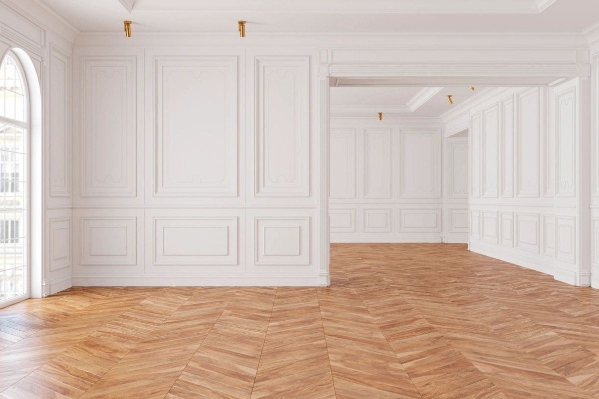 A room with white walls and wooden floors.