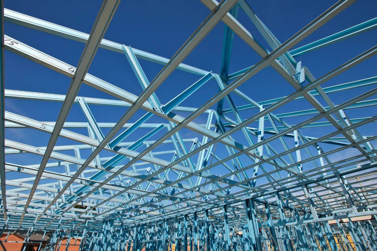 A blue metal structure with many white beams.
