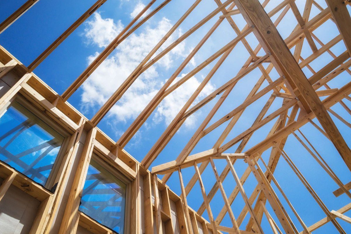 A wooden structure under construction with blue sky.